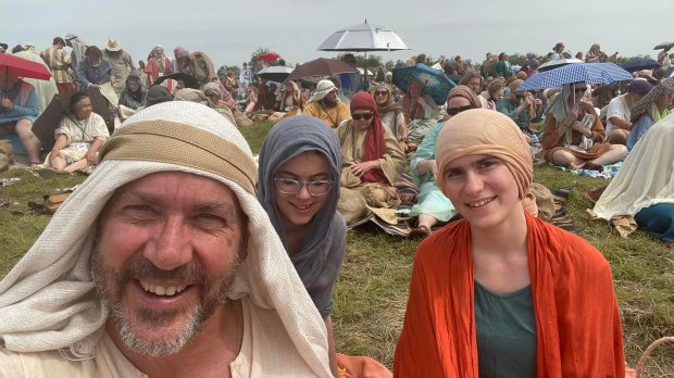 Father and daughters pose on the set of the Chosen