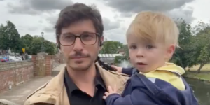 Viral video: Journalist gives live report with squirmy toddler in his arms