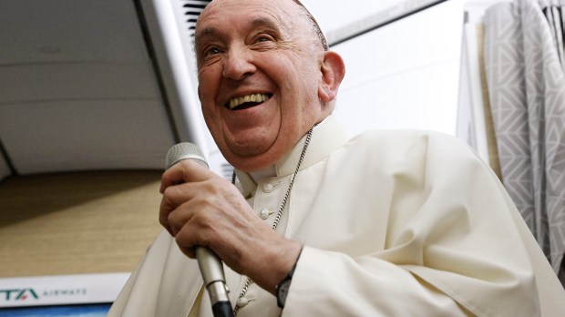 Pope-Francis-reacts-as-he-speaks-during-a-news-conference-aboard-the-papal-plane-AFP-000_32FP6FA.jpg