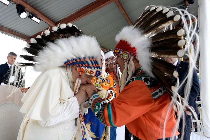 Pope Francis wearing a headdress Indigenous leaders at Muskwa Park in Maskwacis, Edmonton