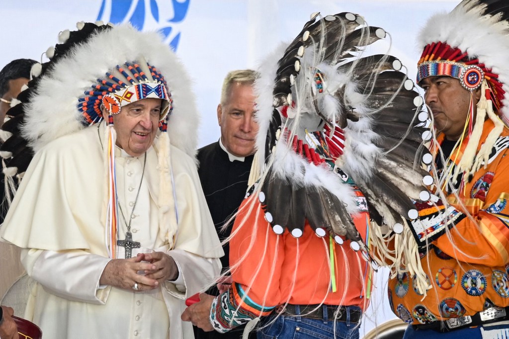 Pope-Francis-wears-a-headdress-Indigenous-leaders-at-Muskwa-Park-in-Maskwacis-Canada-AFP