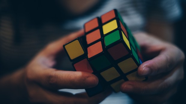 a child holds a rubik's cube