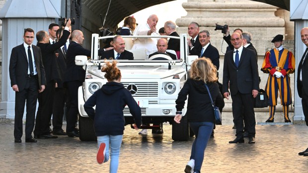 Pope-Francis-waves-as-he-arrives-for-the-weekly-general-audience-AFP