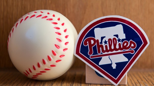 The emblem of the Philadelphia Phillies baseball club and a baseball.
