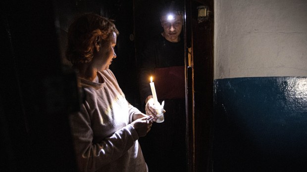 Ukrainian civilians use candlelight