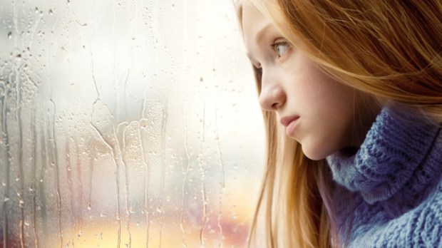 sad teen window rain