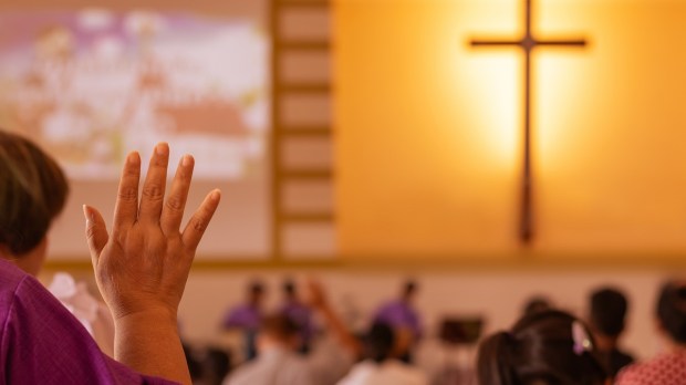 Catholic Mass Pews hand raised