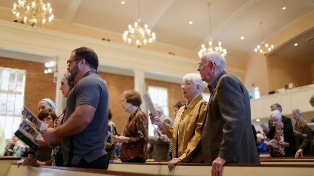 PEOPLE SING IN CHURCH