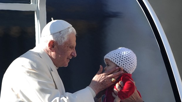 Pope-Benedict-XVI-holds-a-little-girl-at-the-end-of-his-weekly-general-audience-in-Saint-Peters-square-AFP