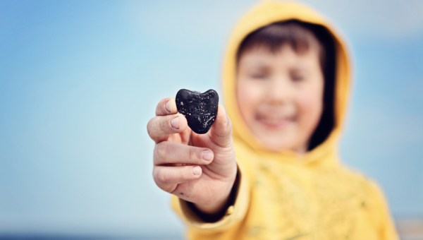 child holding a stone