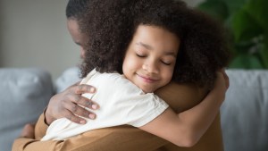 little kid girl hugging cuddling bonding at home