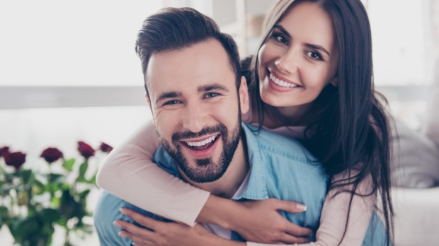 happy husband and wife looking at camera