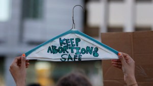 Abortion protester holds up hanger