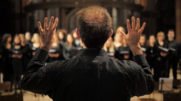 Choir master conducts singers