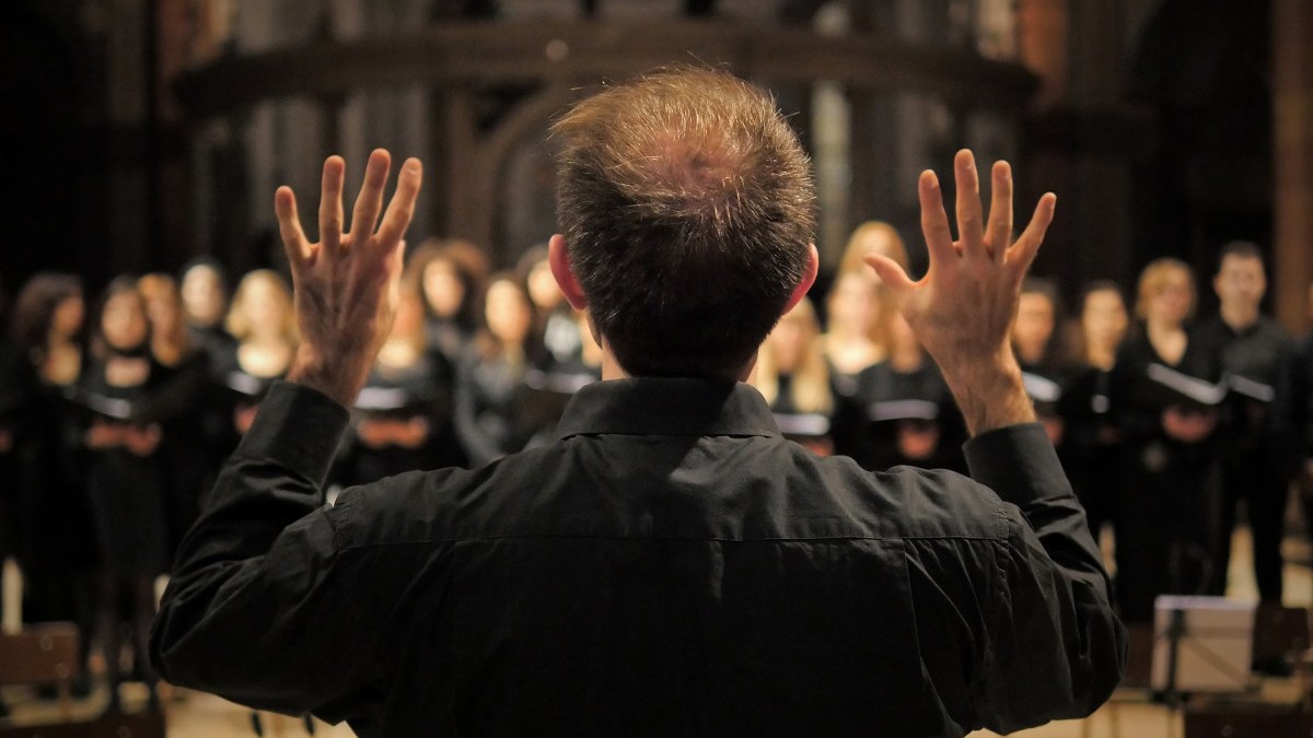 Choir master conducts singers