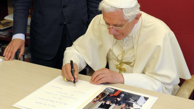 Pope-Benedict-XVI-signing-the-visitors-book-next-to-Osservatore-Romano-editor-in-chief-Giovanni-Maria-Vian-AFP