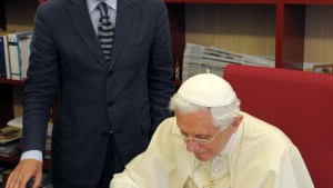 Pope-Benedict-XVI-signing-the-visitors-book-next-to-Osservatore-Romano-editor-in-chief-Giovanni-Maria-Vian-AFP