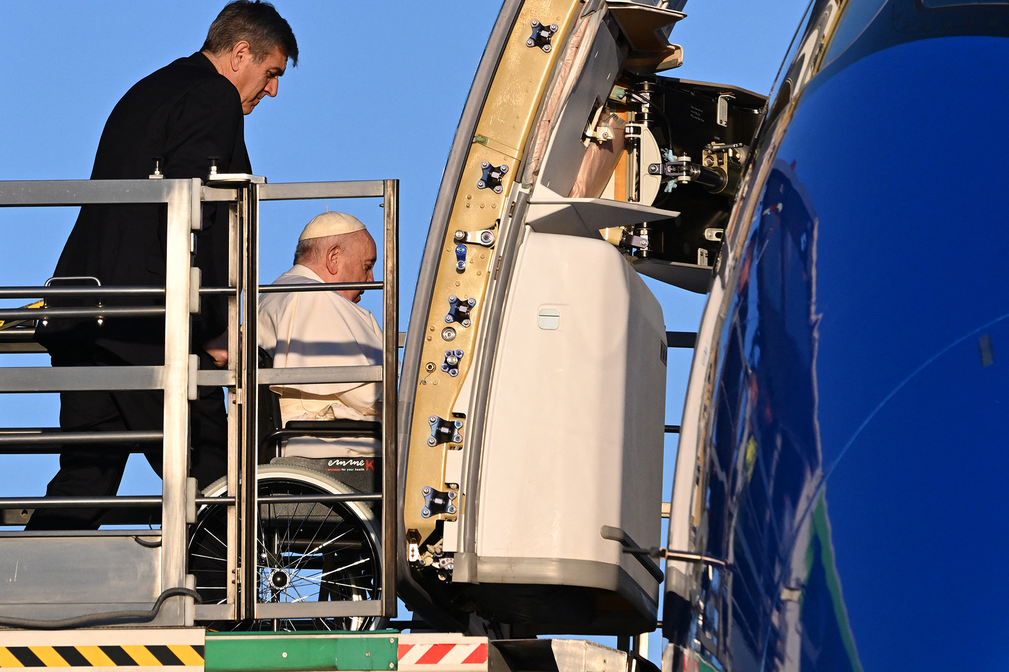 Pope Francis seated on a wheelchair is lifted on a platform to board his plane on January 31, heading to Democratic Republic of Congo and South Sudan.