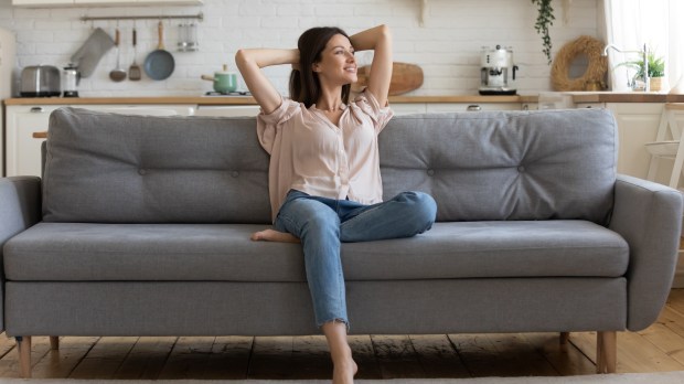 happy single woman on sofa