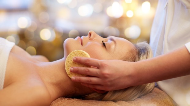 woman at spa getting facial treatment