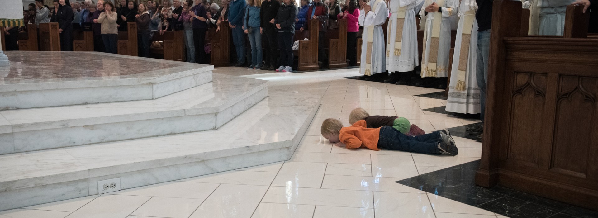 two boys and a dad at ordination in Denver cathedral