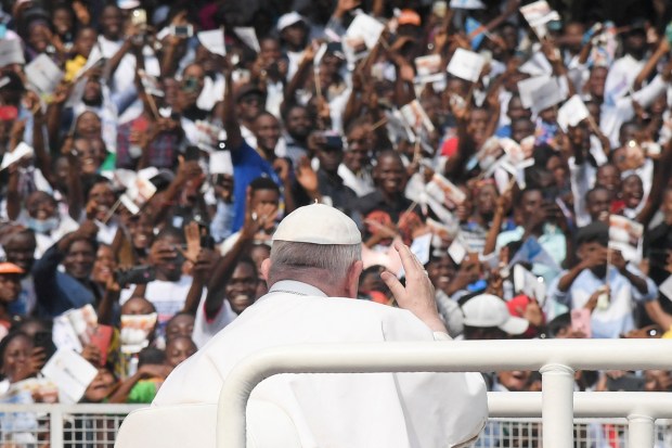 Pope-Francis-waves-as-he-arrives-by-popemobile-for-a-meeting-with-young-people-and-catechists-at-Martyrs-Stadium-in-Kinshasa-AFP
