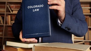 Colorado law book held by man