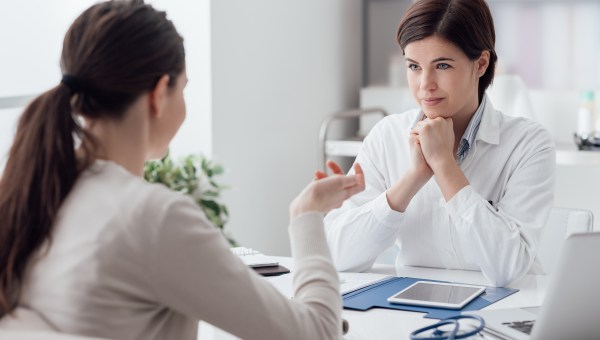 Doctor working in the office and listening to the patient