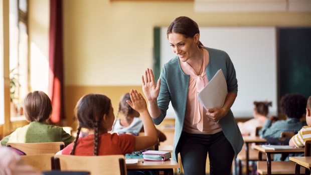 Good teacher high five student classroom