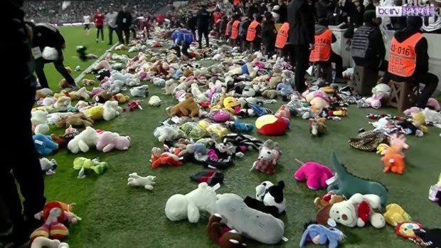Turkish football fans teddy bears pitch