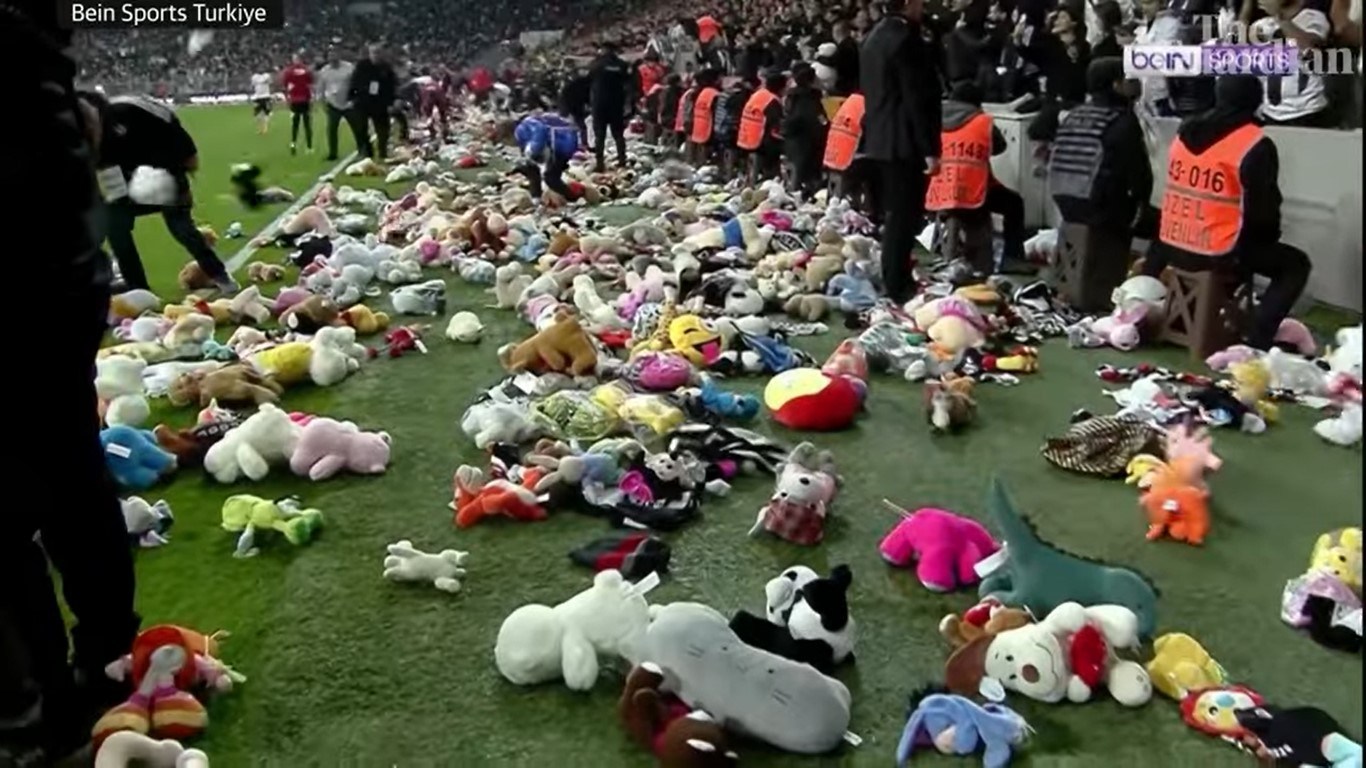 Turkish football fans teddy bears pitch