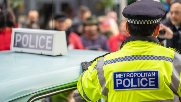 UK police officer standing near car