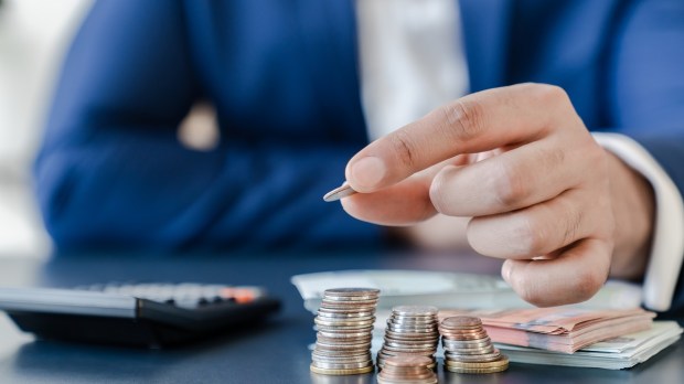 Man counts money with calculator