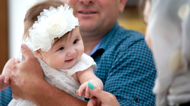 baby at baptism with godparents