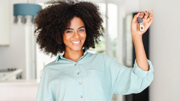 woman holding up keys