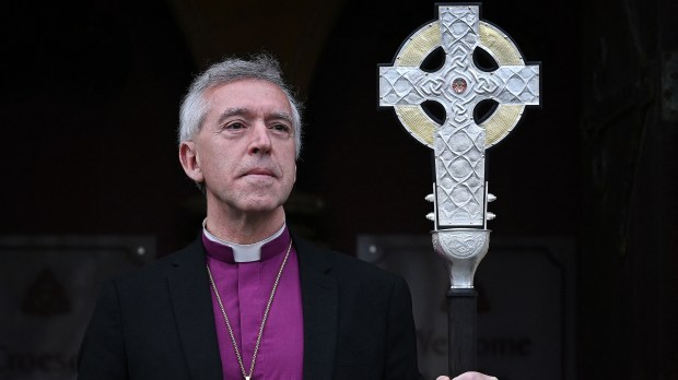 Archbishop of Wales, Andrew John poses with 'The Cross of Wales' ahead of a ceremony to bless the Cross at Holy Trinity Church in Llandudno
