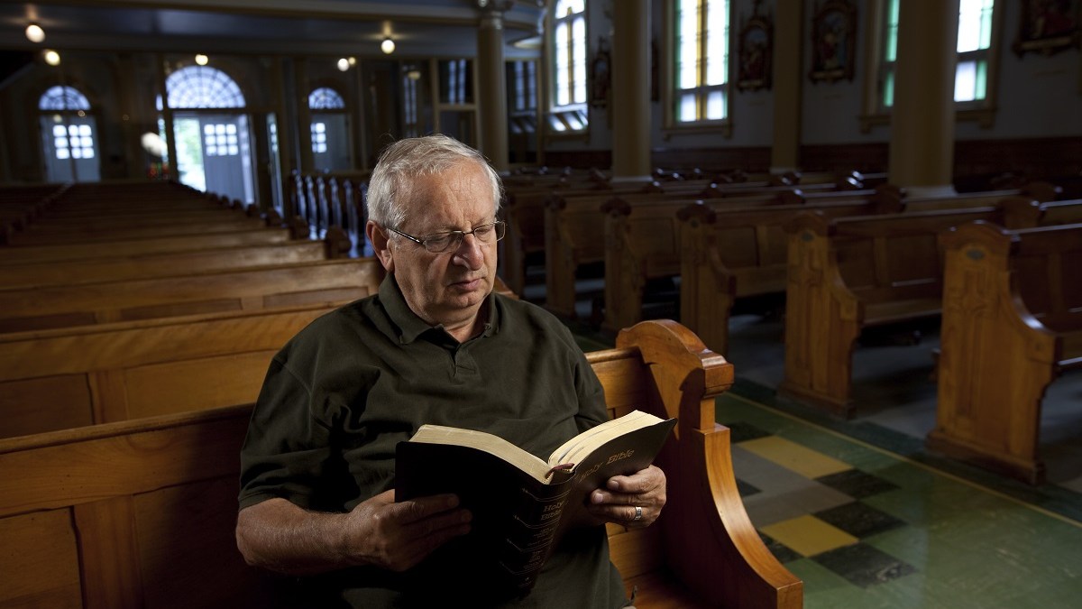 Old man sitting alone in church