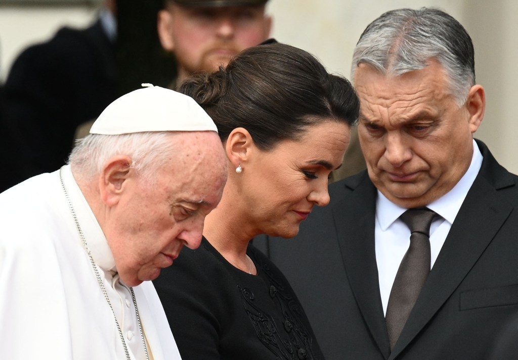 Pope Francis and Hungary's President Katalin Novak walk past Hungary's Prime Minister Viktor Orban as they attend a welcome ceremony at Sandor Palace in Budapest on April 28, 2023