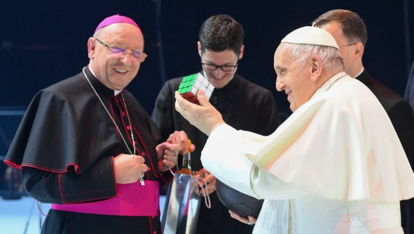 Pope Francis holds up a rubik's cube he received during a meeting with young people at Papp Laszlo Sportarena during his visit in Budapest Hungary