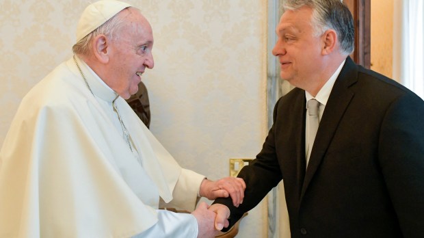 Pope Francis shaking hands with Hungary's Prime Minister Viktor Orban