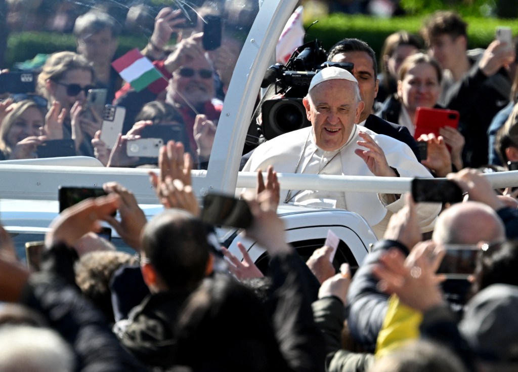 Pope Francis waves as he arrives to celebrate a holy mass at Kossuth Lajos' Square during his visit in Budapest