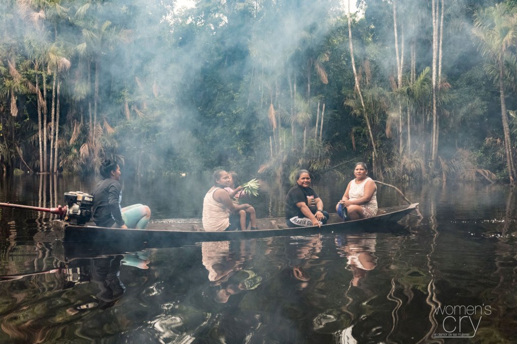 Indigenous women on a boat in the Amazon river in Brazil