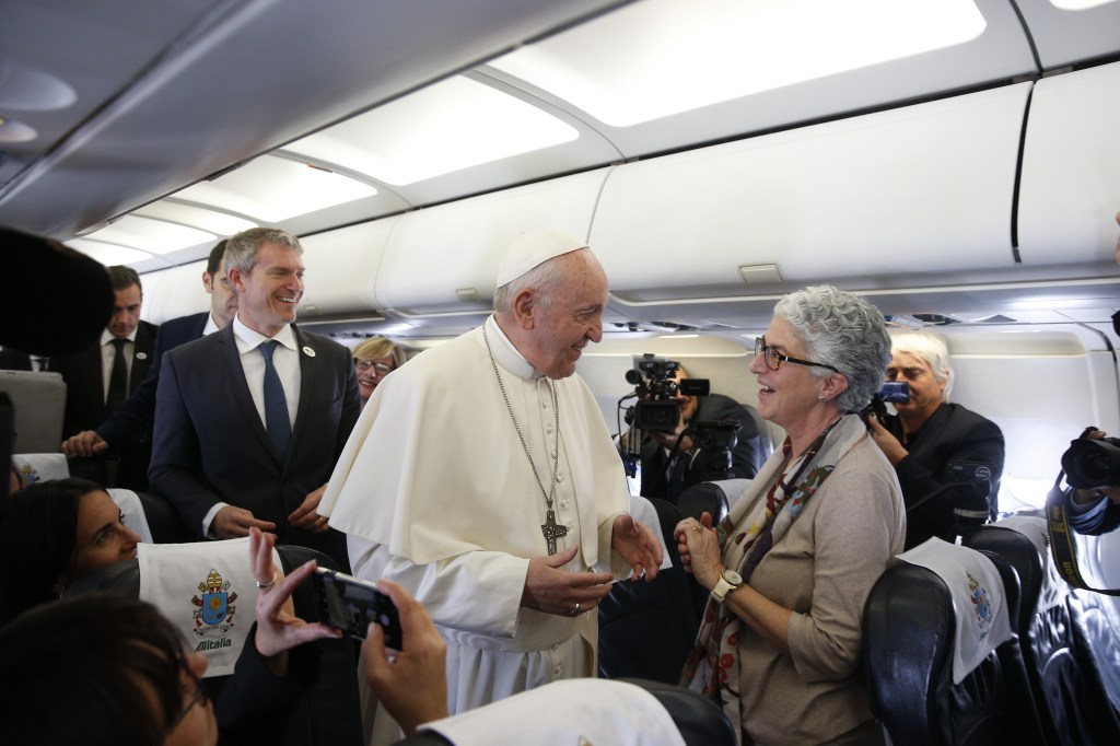 Portuguese journalist Aura Miguel greets Pope Francis on a papal flight