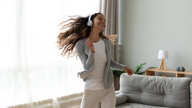 Woman dancing alone with headphones on