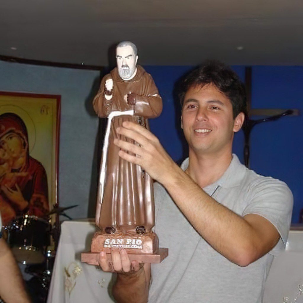 Venerable Guido Schäffer holding a statue of Padre Pio