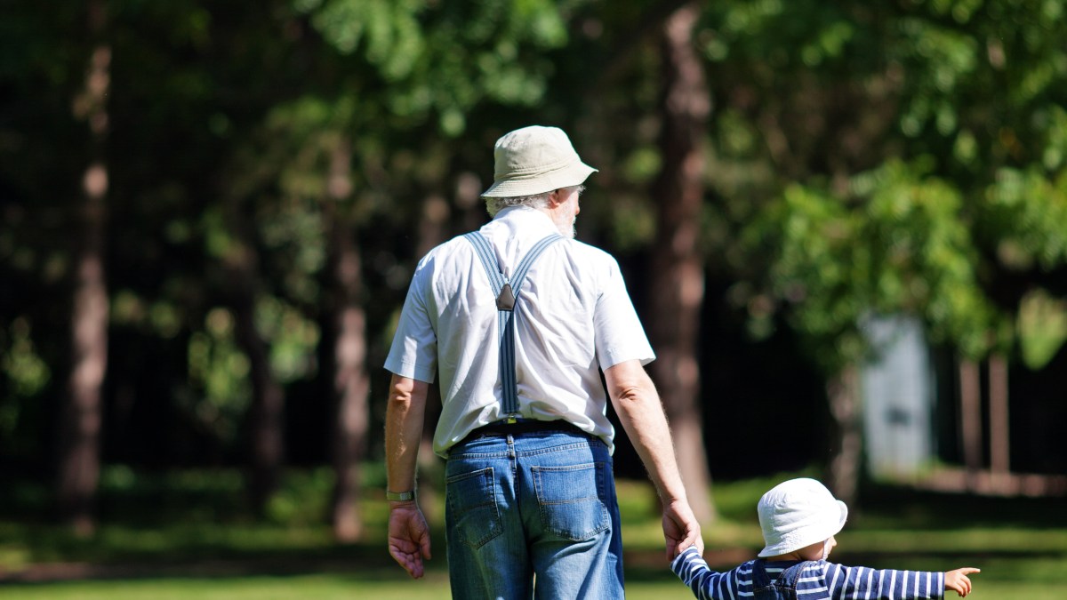boy grandfather walk park