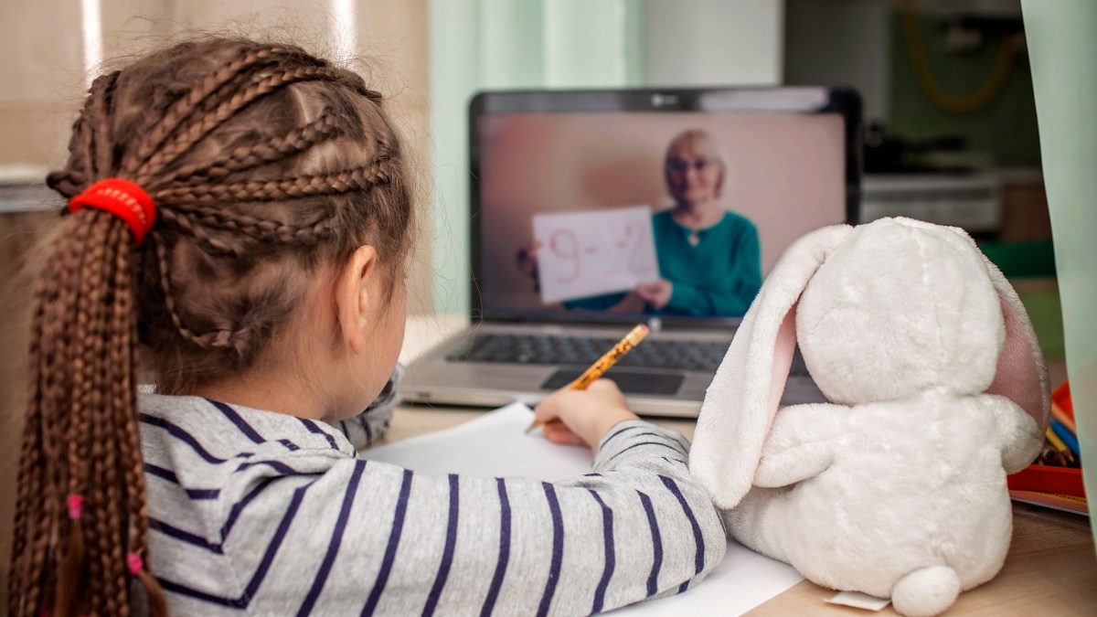 Girl listening to teacher through internet