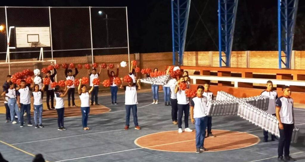 Students in Bolivia holding up a giant rosary made from plastic bottles