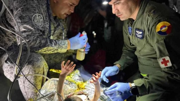 Rescuers give medical attention to child rescued from Amazon jungle