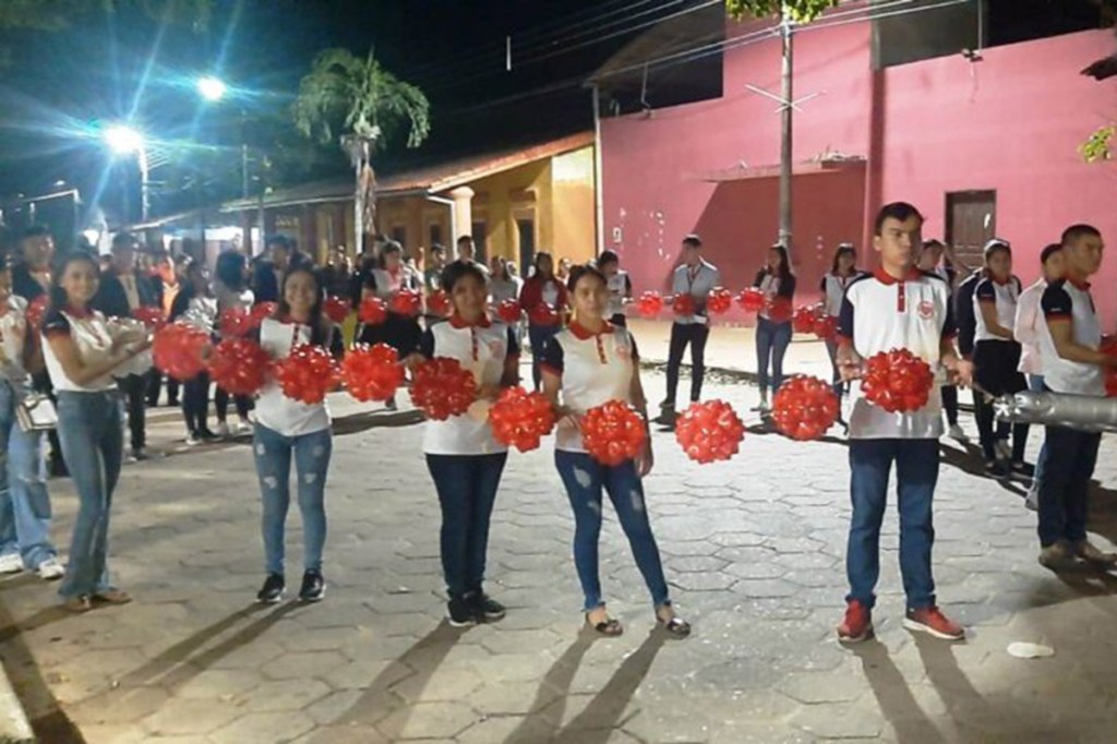 Students in Bolivia carry a giant rosary around the city's main square as they pray